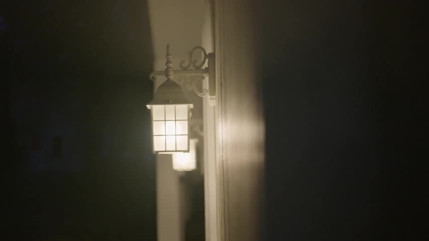 Two lights illuminate the outside of a house