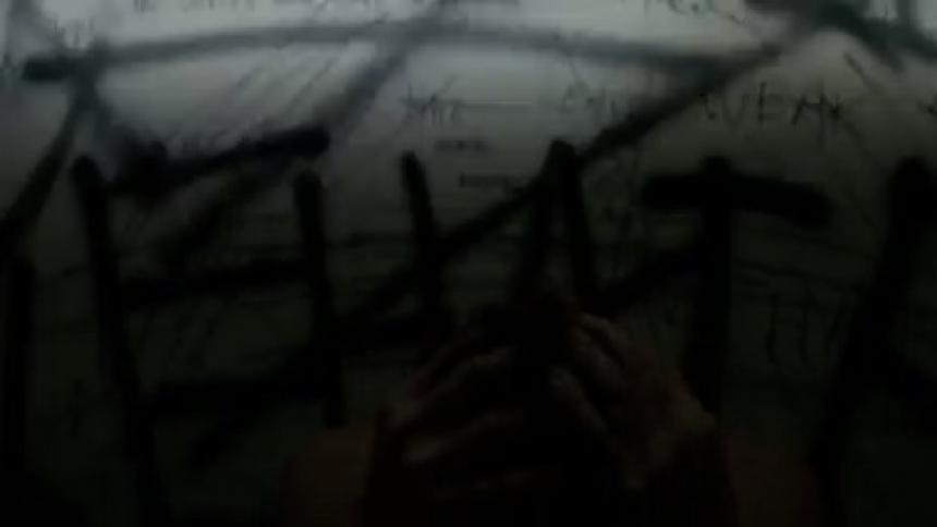 A man is having a breakdown in a room with a flashing light