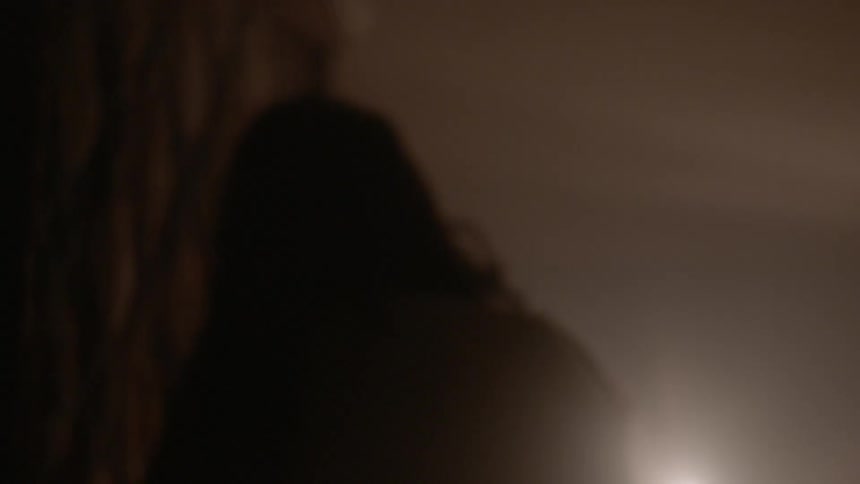 A woman is walking through a house
