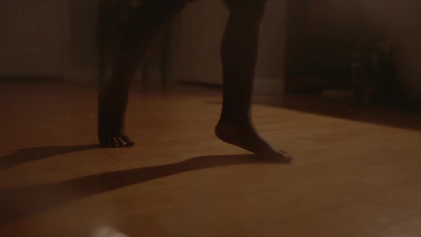 A child walks on their toes