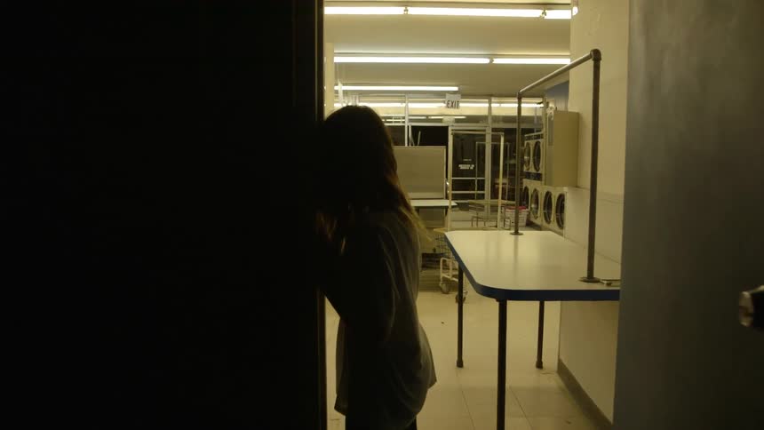 Young woman rests against the doorway