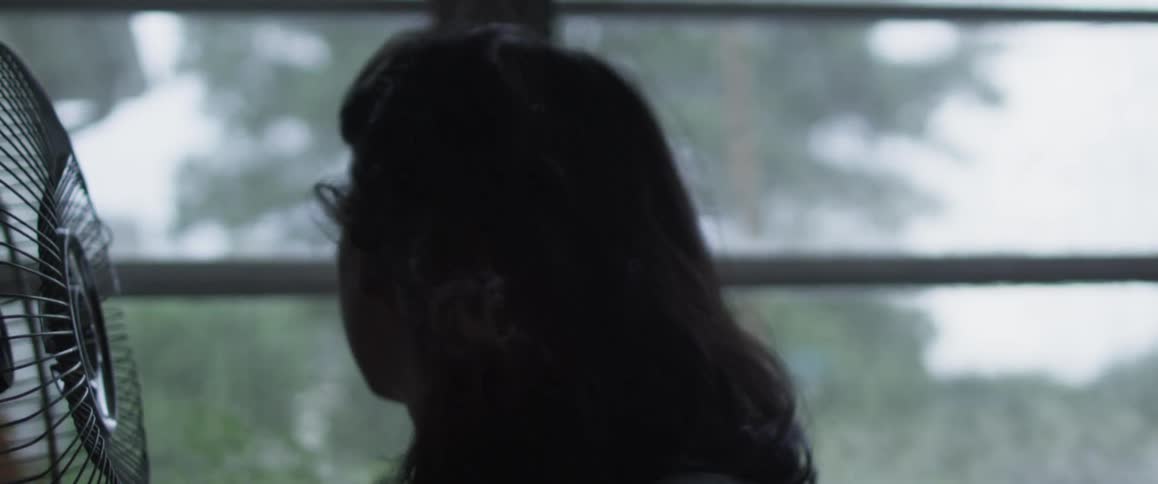 A woman's hair is blown by the wind