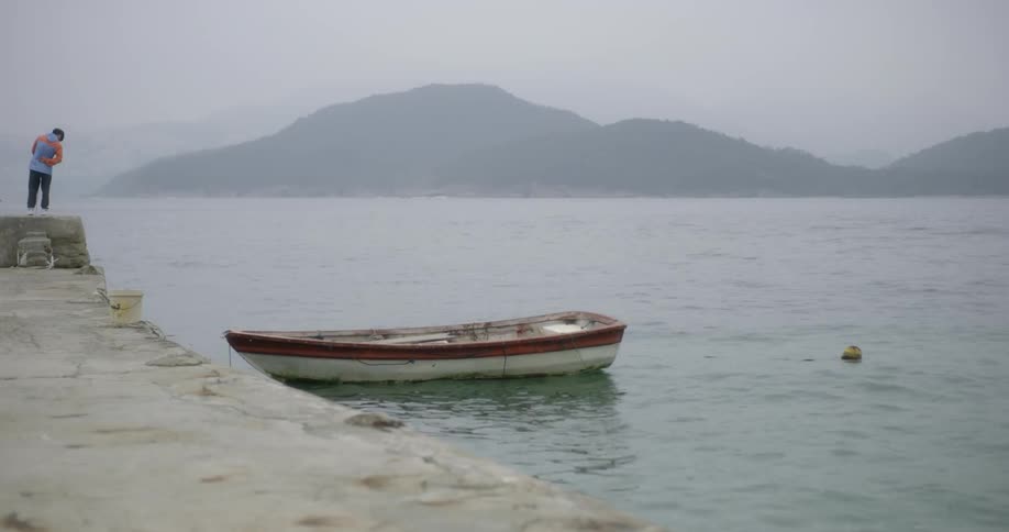 A boat bobs near a dock