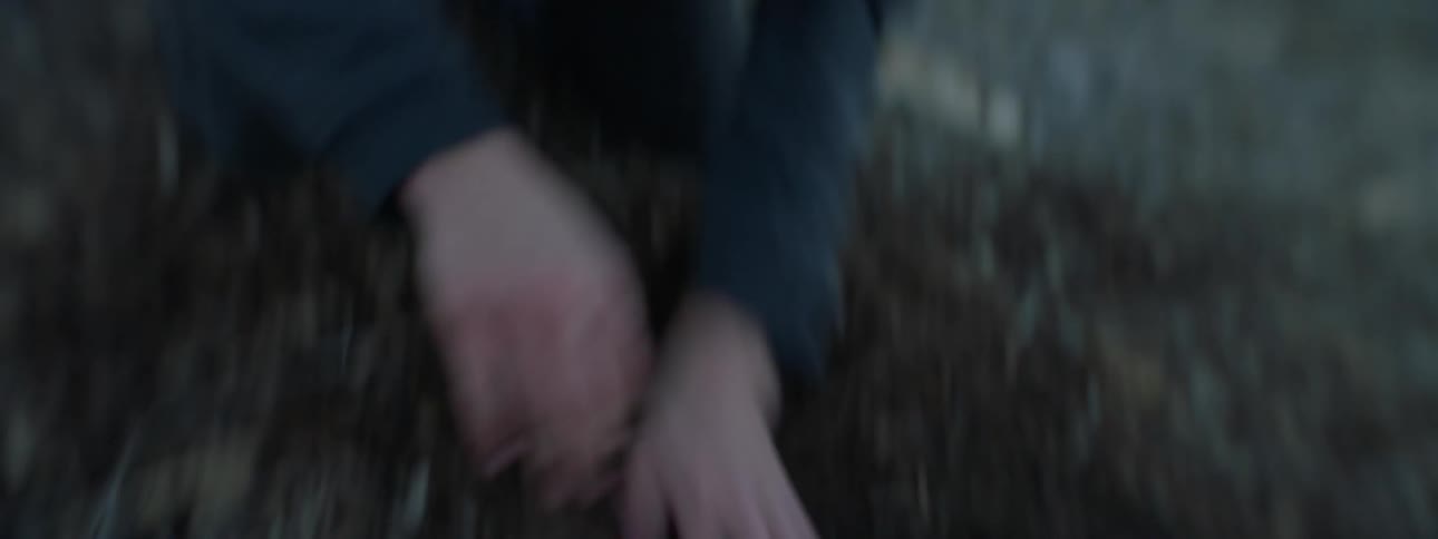 A teenage boy is digging and scratching in the dirt