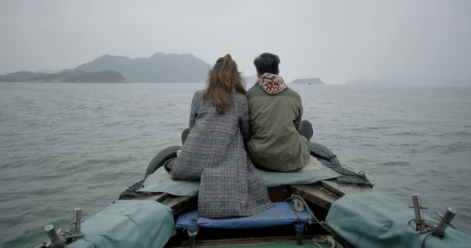 Man and woman ride a boat together