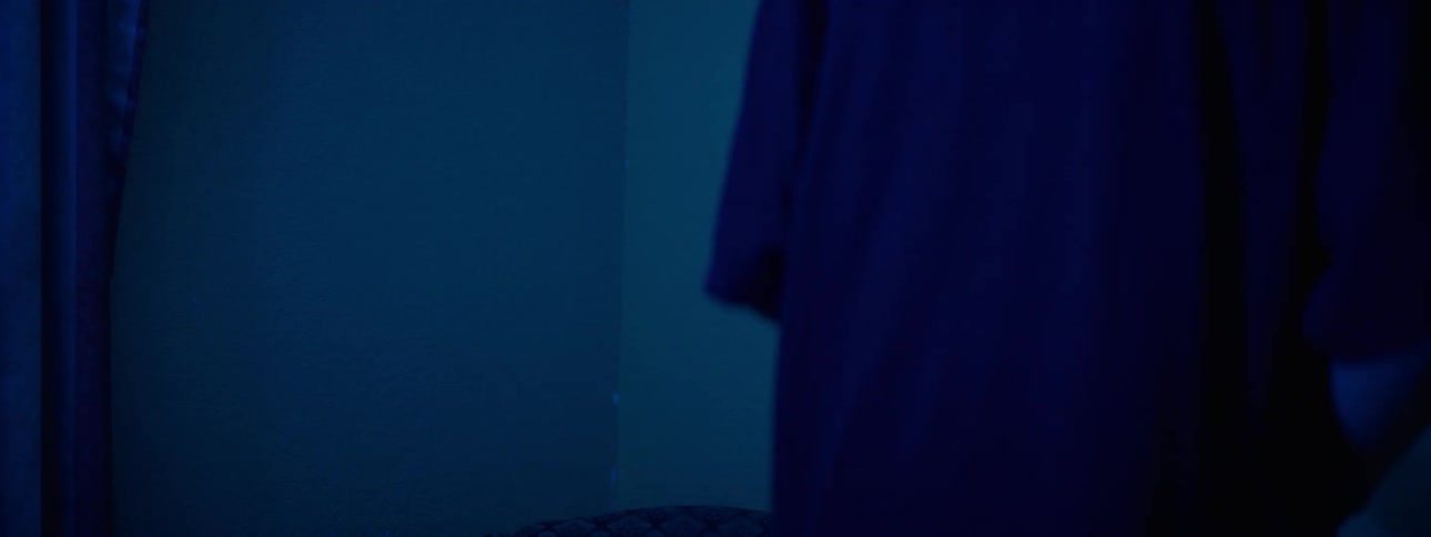 Lights flash in a dark bedroom at night