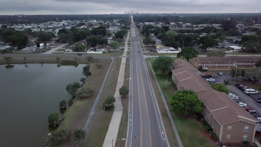 Cars drive down the road in this town