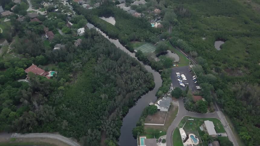 A community lines the shores and canals of a wetlands coastal area