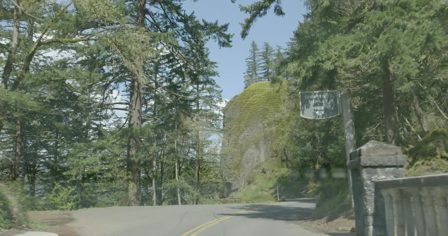 Driving across a small bridge on an asphalt road in the mountains