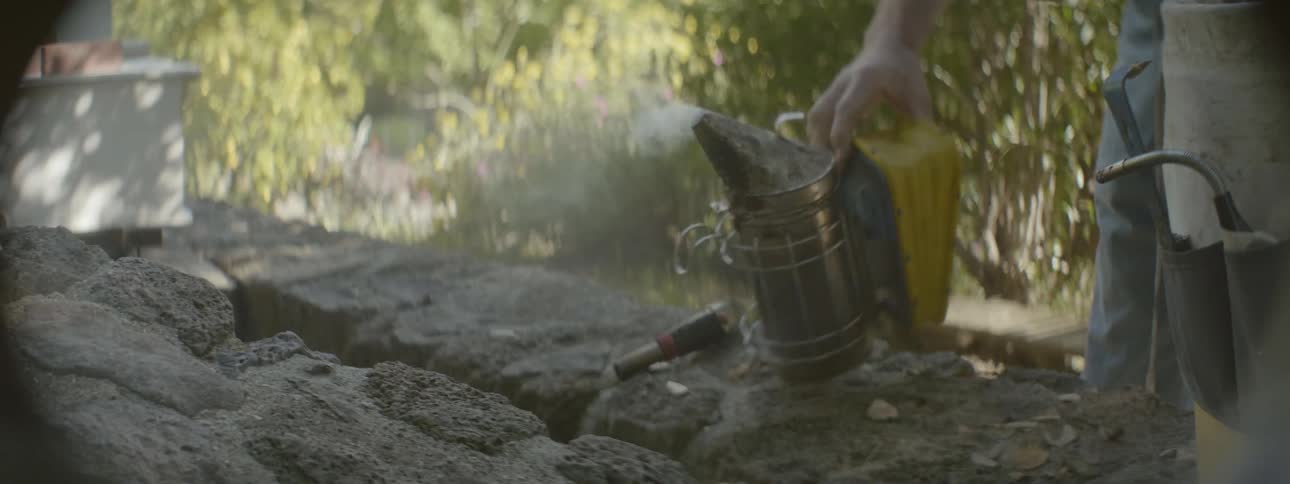 A person picks up a steamer and uses it on their hands