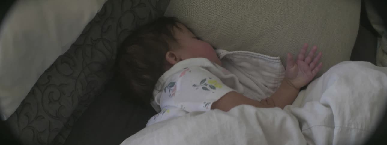 A baby is sleeping in the crib