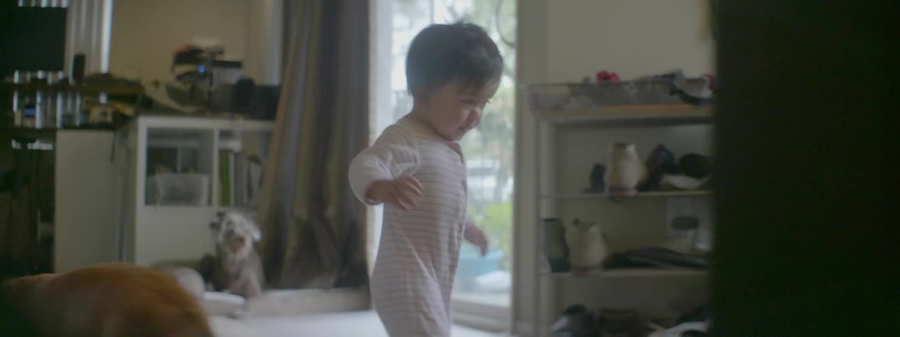 A baby walks on the carpet