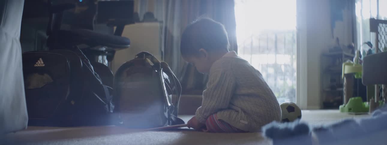 A baby is sitting on the floor playing with a book