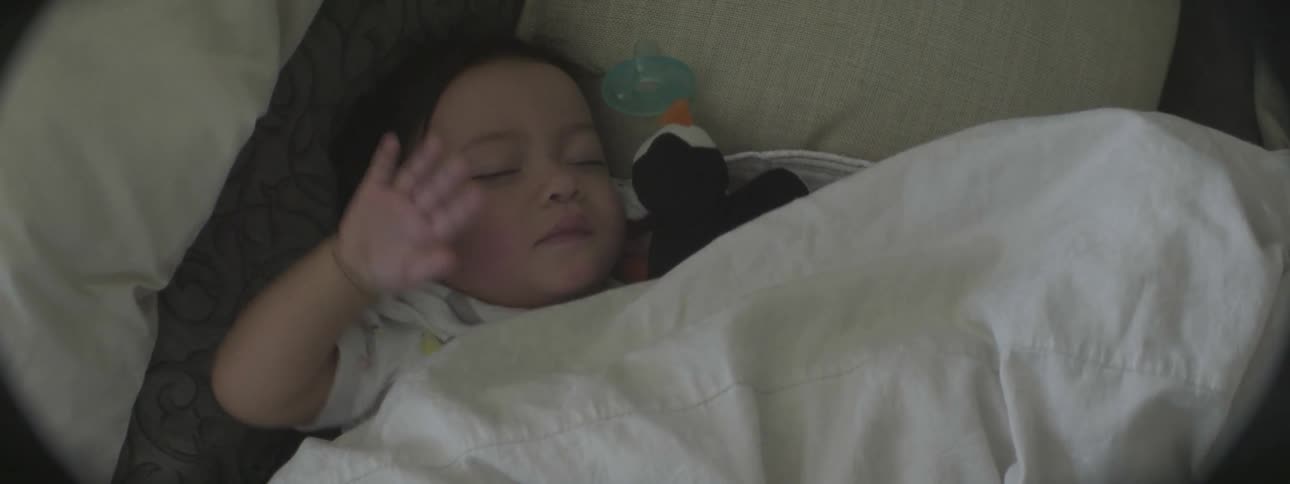 A sleeping baby moves in his sleep