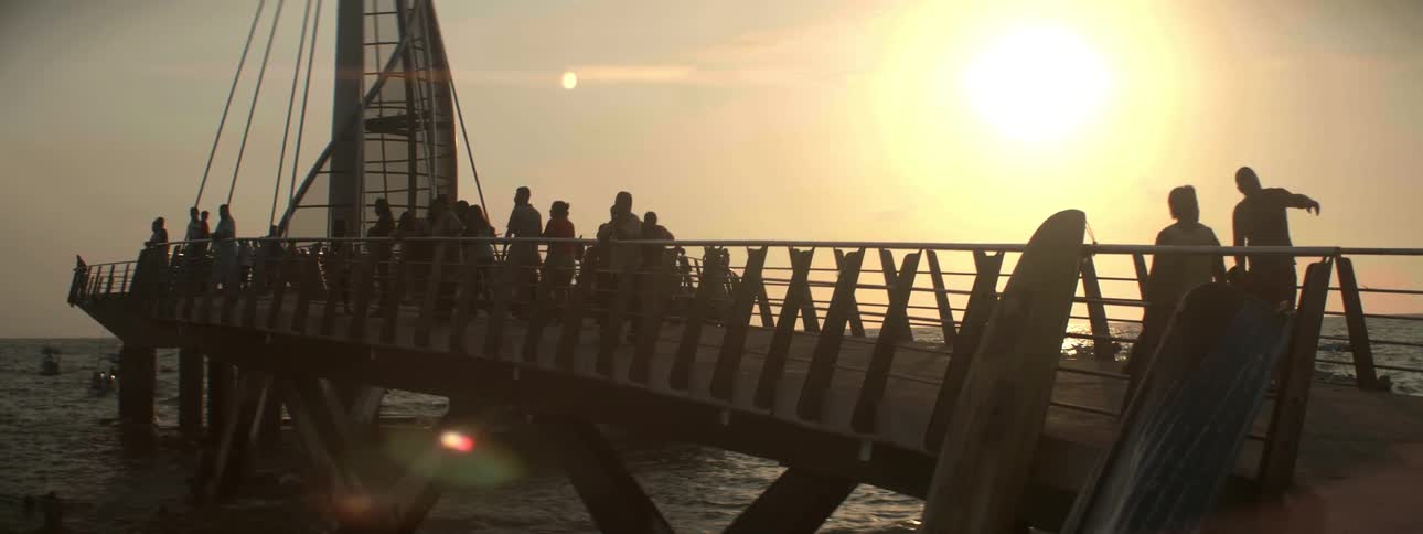 People walk along a dock