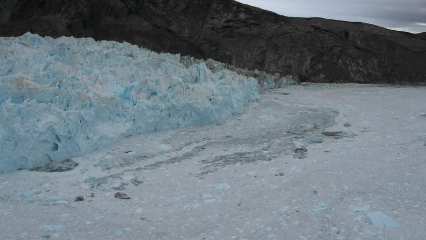 Blue ice near a mountain's base