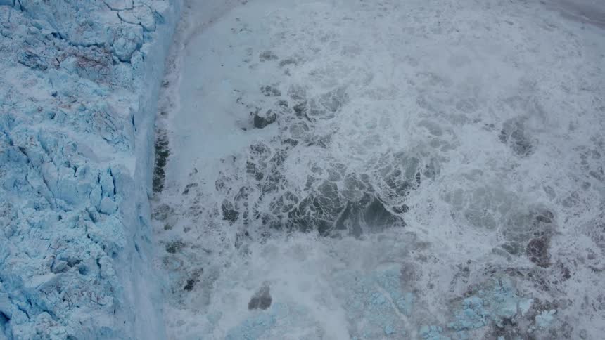 The water below is splashing against the ice