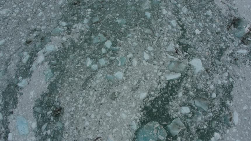 Ice chunks cover the frozen water