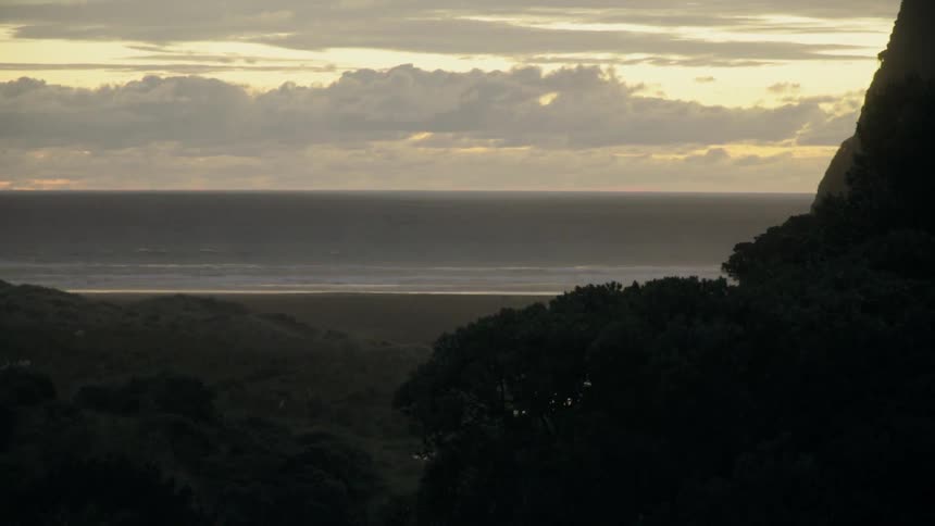 The sun is setting over the shore ahead