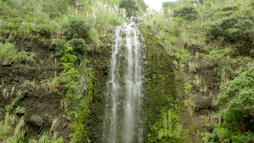 A waterfall is being filmed by a drone