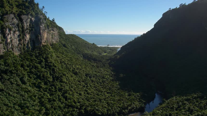 The mountain range leads to the shore