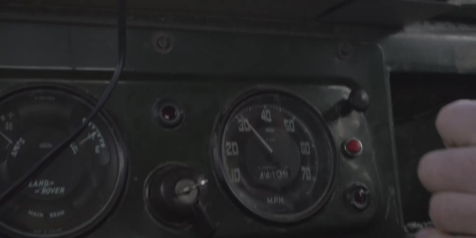 A white person shifts gears in a moving vehicle