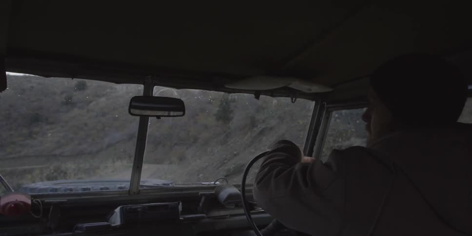 Man driving his vehicle through the mountains