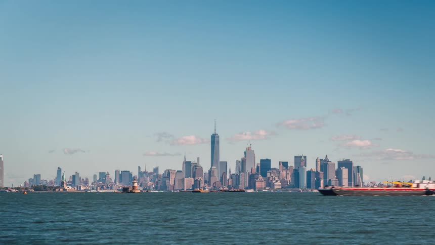 Barges and boats travel near a city