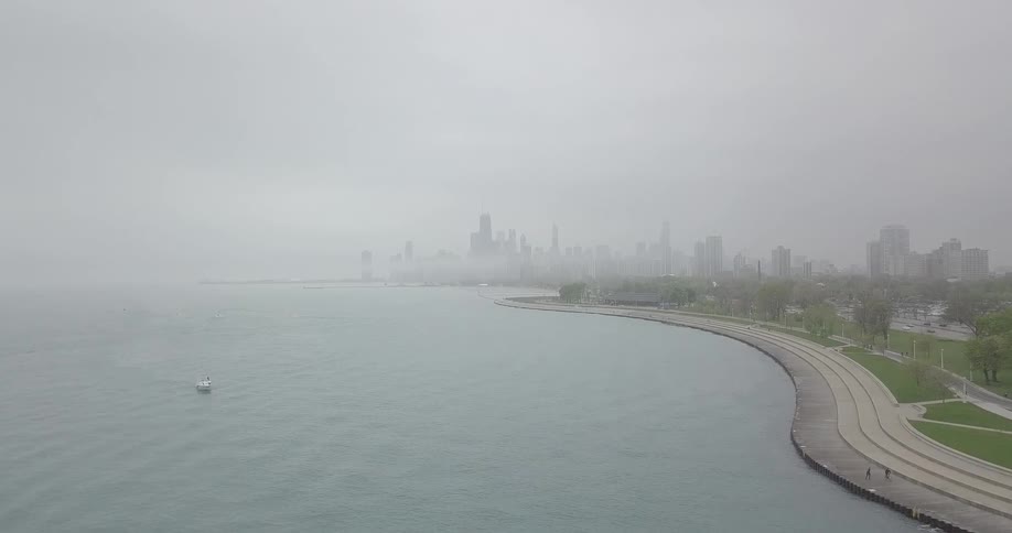 The city by the water is covered in heavy fog