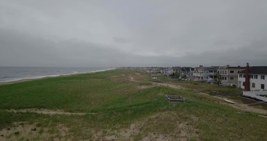 Waves flow onto the coastline of a coastal town