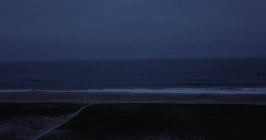 The waves crash against the shore of this town