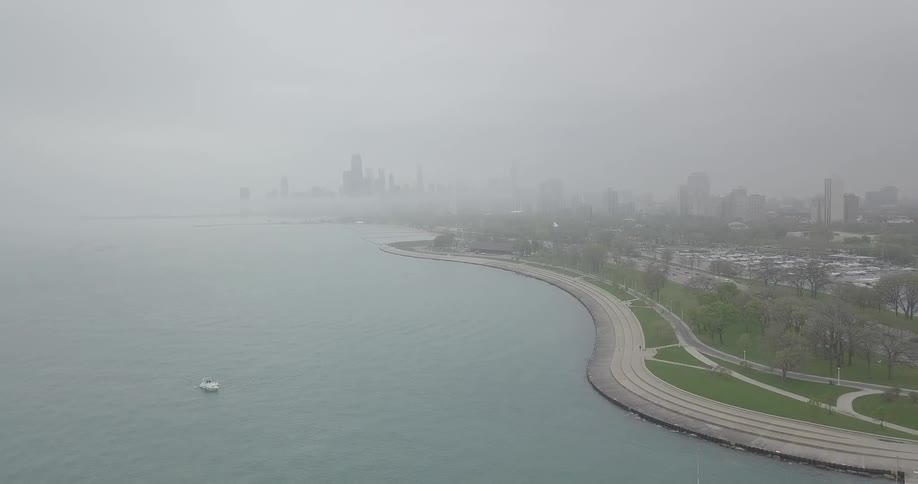 A large city and body of water is being filmed by a drone
