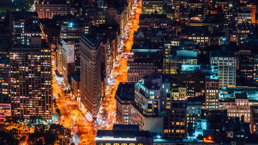 Traffic moves through a city at night