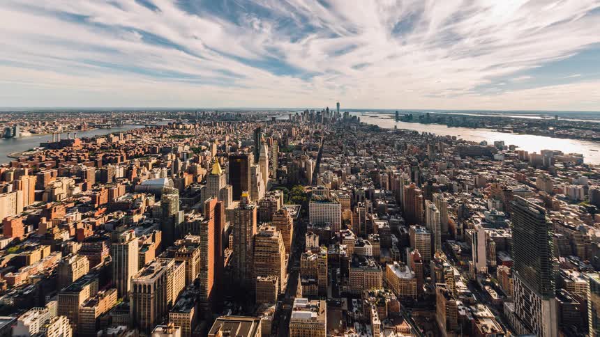 Clouds pass over a city and harbor during the day