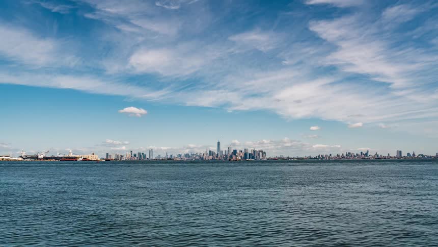 A city skyline is observed from across the water