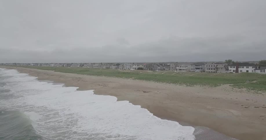 A beach near rows of houses