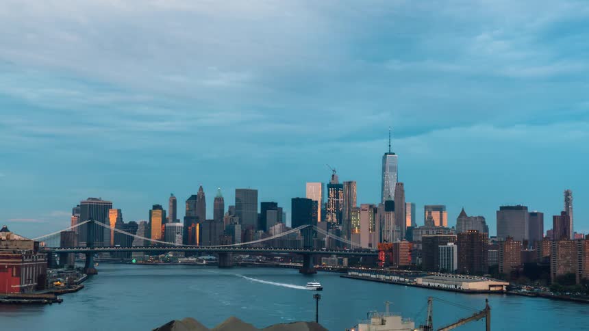 The city past the water has a large tower on the right