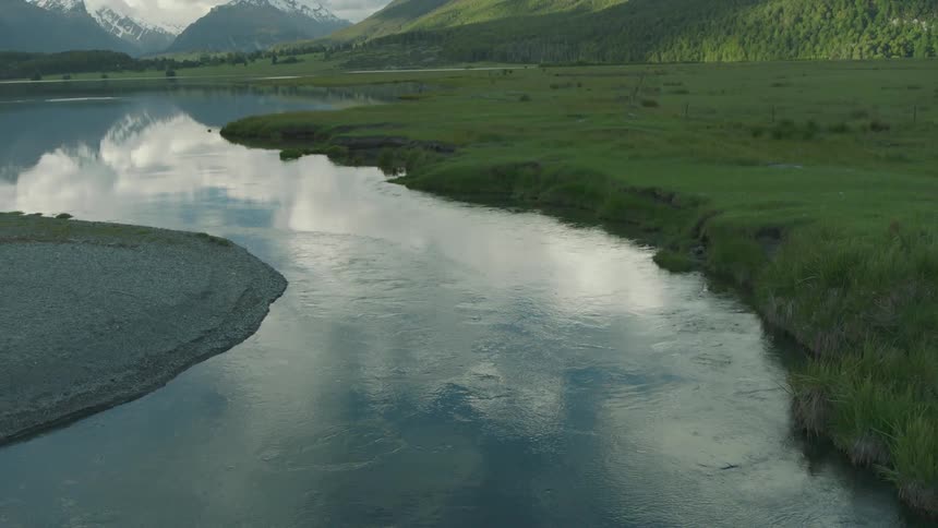 River winding through green grasses and hills