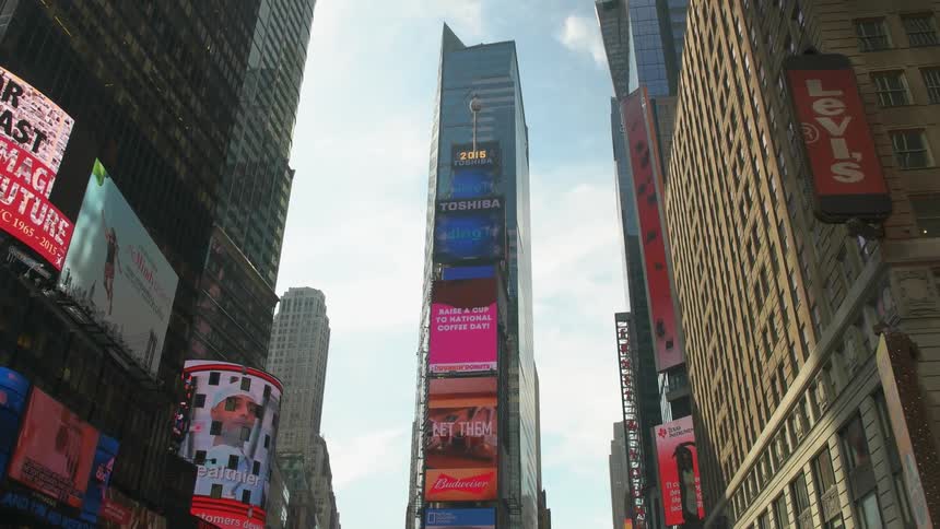 Video signs and marquees flash on buildings on a city block