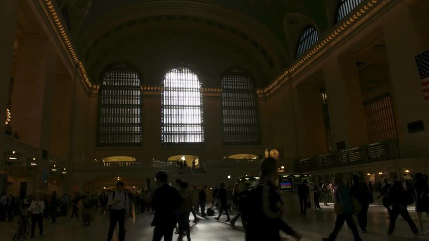 Many people walking inside a large public building