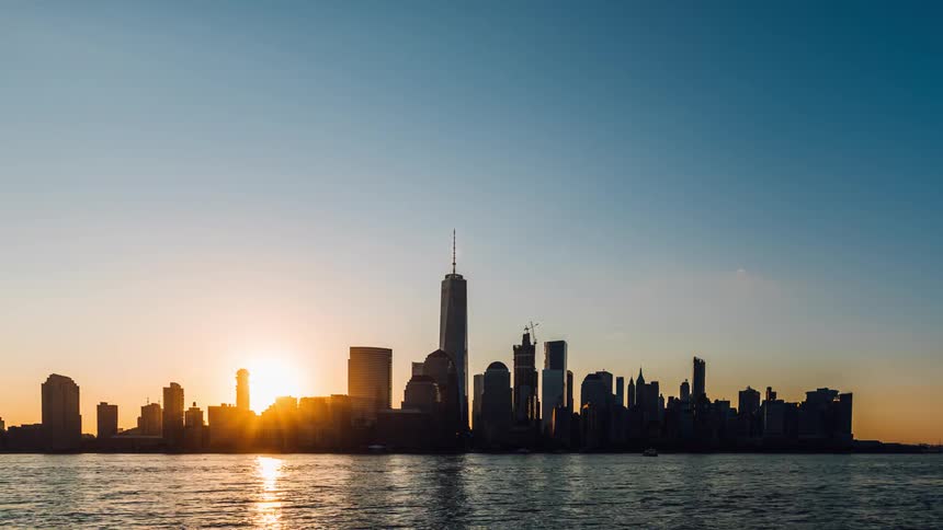 River flowing in front of a city at sunrise