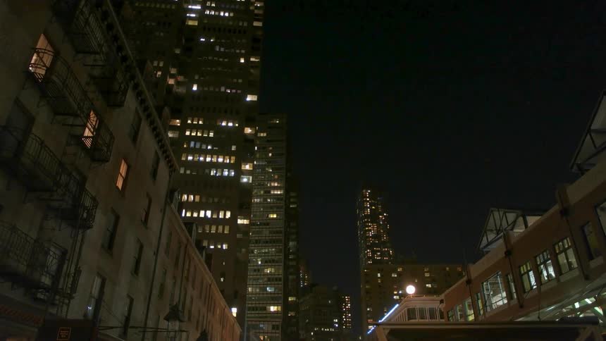 City skyscrapers illuminate the night sky