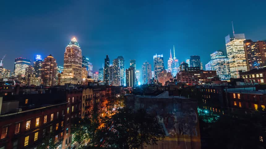 City skyscrapers illuminate the night sky