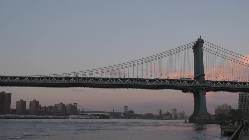 Traffic travels on a bridge over a body of water