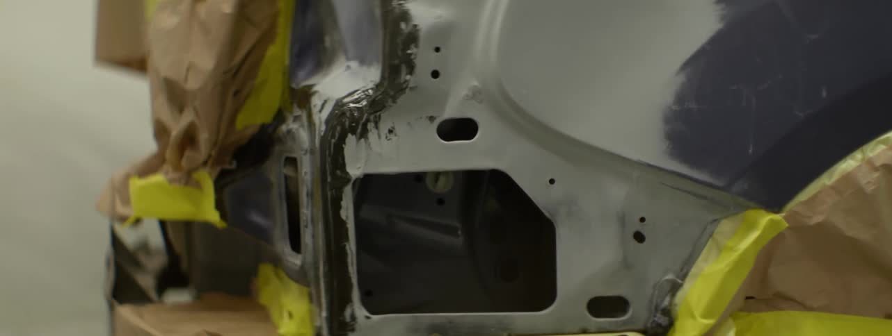 Large hole and several small holes in a piece of metal