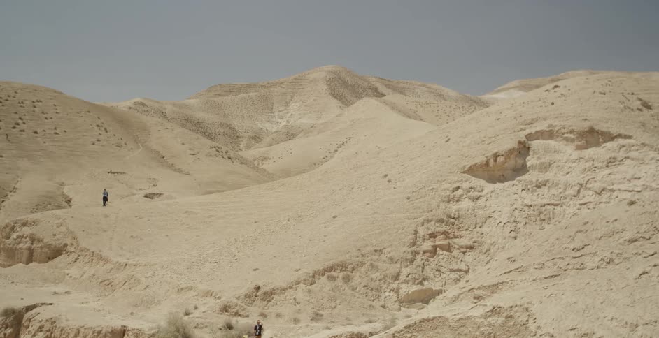 People walk on the hills of this desert