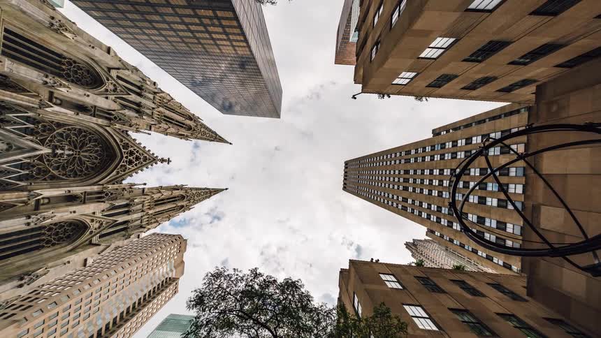 Clouds move fast over this square of buildings