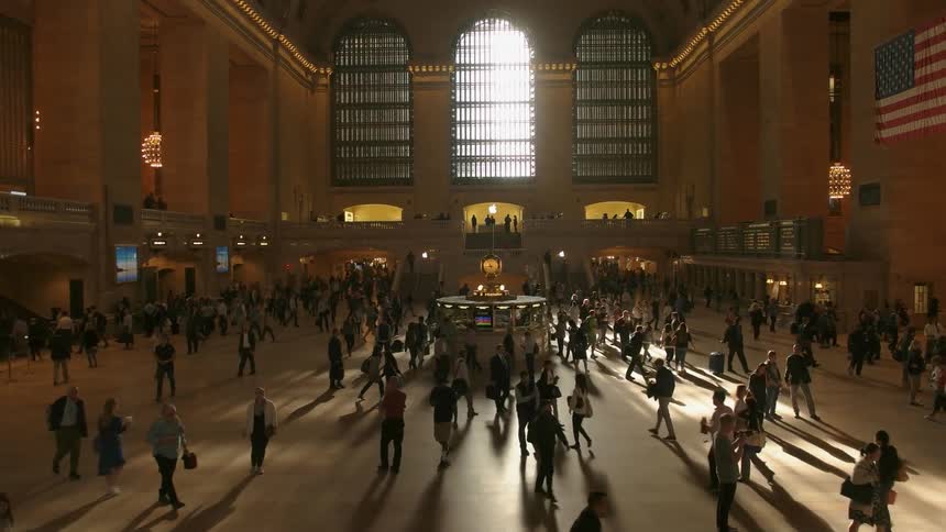 Many people walking inside a large public building