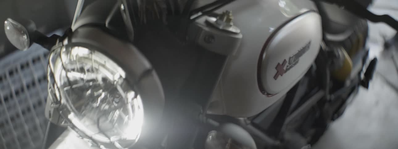 A headlight on a motorcycle is shining