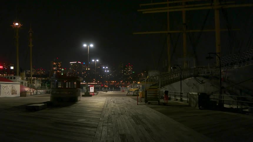Movement in a dark area in what looks like a shipyard